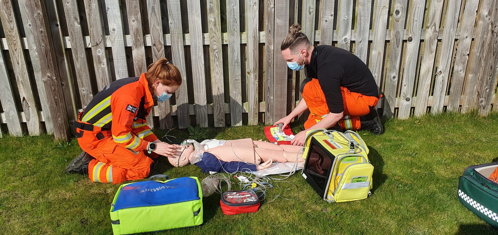 Paramedic Sophie And Dr Jono Training on a manikin, surrounded by kit bags Paramedic Sophie And Dr Jono Training on a manikin, surrounded by kit bags