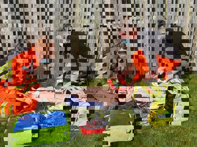 Paramedic Sophie And Dr Jono Training on a manikin, surrounded by kit bags Paramedic Sophie And Dr Jono Training on a manikin, surrounded by kit bags