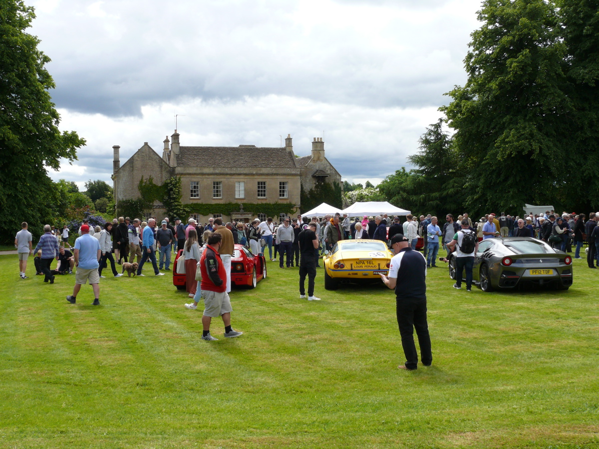 A photo of a house and cars, with people walking around A photo of a house and cars, with people walking around