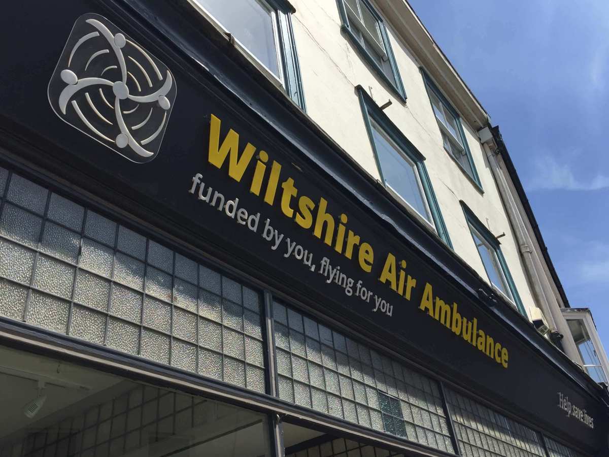 Wiltshire Air Ambulance's Devizes charity shop signage with yellow and white writing Wiltshire Air Ambulance's Devizes charity shop signage with yellow and white writing