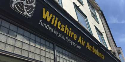 Wiltshire Air Ambulance's Devizes charity shop signage with yellow and white writing Wiltshire Air Ambulance's Devizes charity shop signage with yellow and white writing