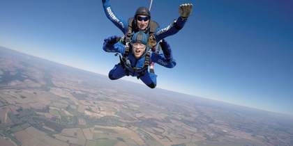 A skydiver in the air over Wiltshire county side. A skydiver in the air over Wiltshire county side.