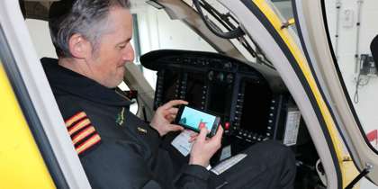 A pilot playing a helifun game on their phone inside the cockpit of the Bell-429 helicopter. A pilot playing a helifun game on their phone inside the cockpit of the Bell-429 helicopter.