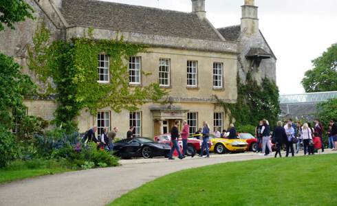 A photo of Middlewick House with sports cars parked outside and visitors taking photos and looking at the cars. A photo of Middlewick House with sports cars parked outside and visitors taking photos and looking at the cars.