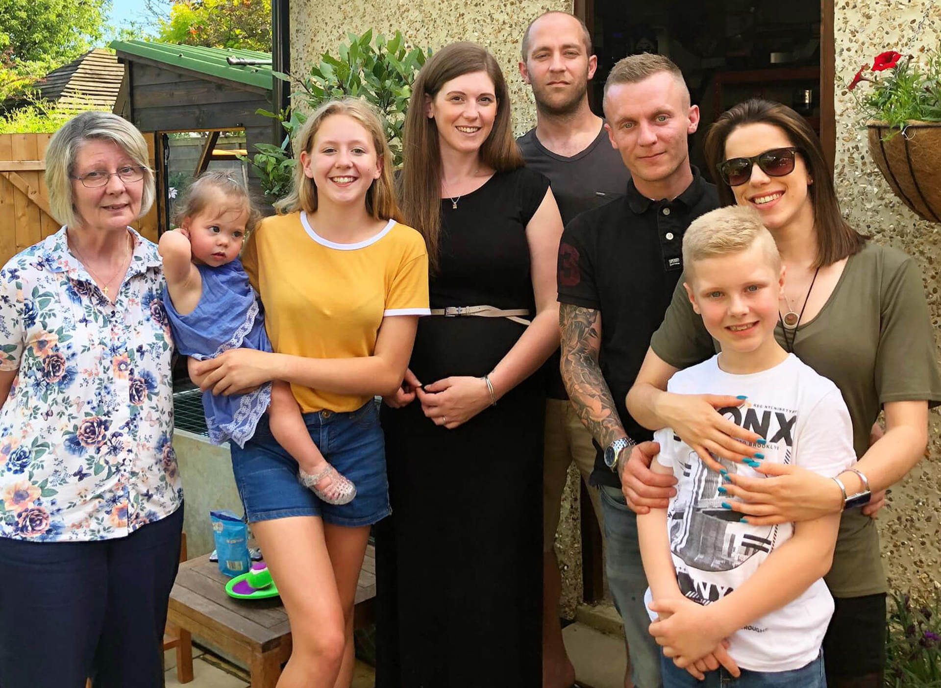 A group of family photographed in a garden A group of family photographed in a garden