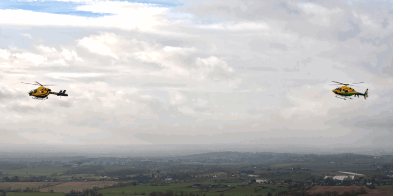 The old Wiltshire Air Ambulance MD-902 helicopter in the air, flying alongside the new Bell-429 helicopter. The old Wiltshire Air Ambulance MD-902 helicopter in the air, flying alongside the new Bell-429 helicopter.