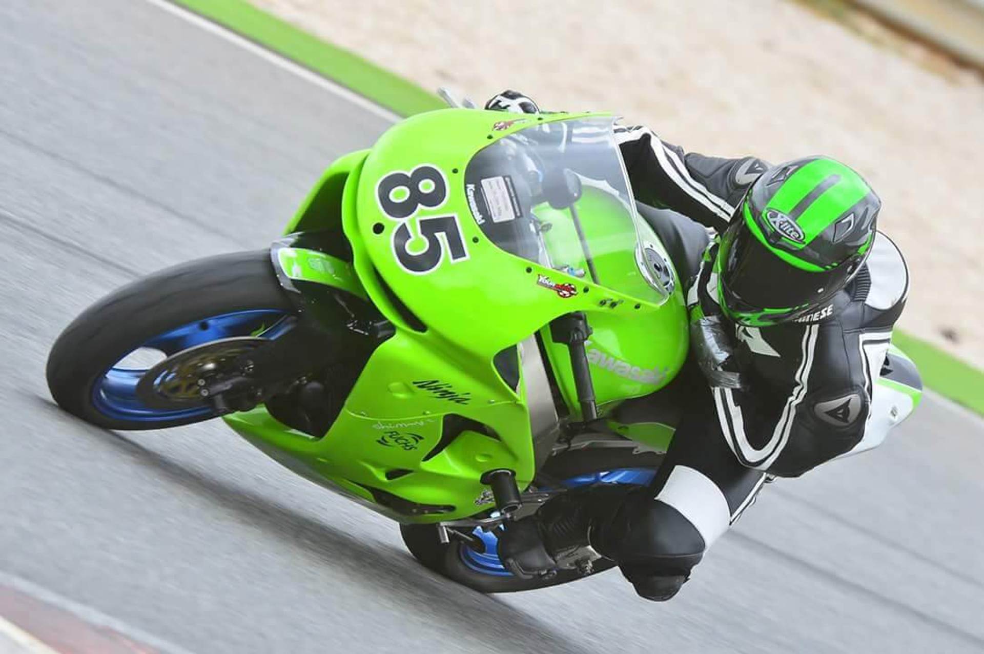 A motorcyclist on a green motorbike A motorcyclist on a green motorbike