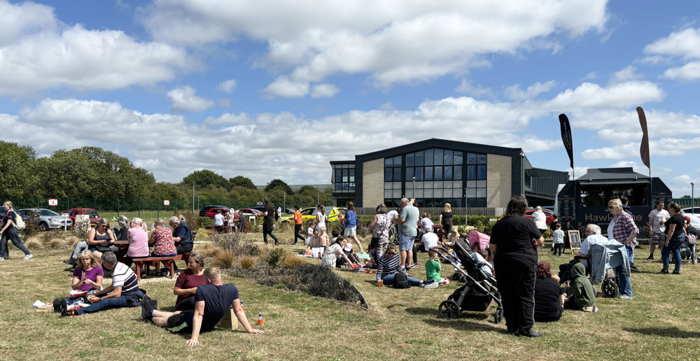 A group of people lounging in the sun at an air ambulance airbase