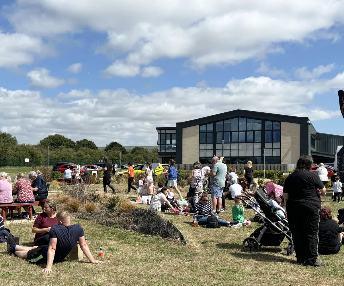A group of people lounging in the sun at an air ambulance airbase A group of people lounging in the sun at an air ambulance airbase