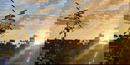 People enjoying the sunset, below a model of the helicopter, at the Wiltshire Air Ambulance airbase People enjoying the sunset, below a model of the helicopter, at the Wiltshire Air Ambulance airbase