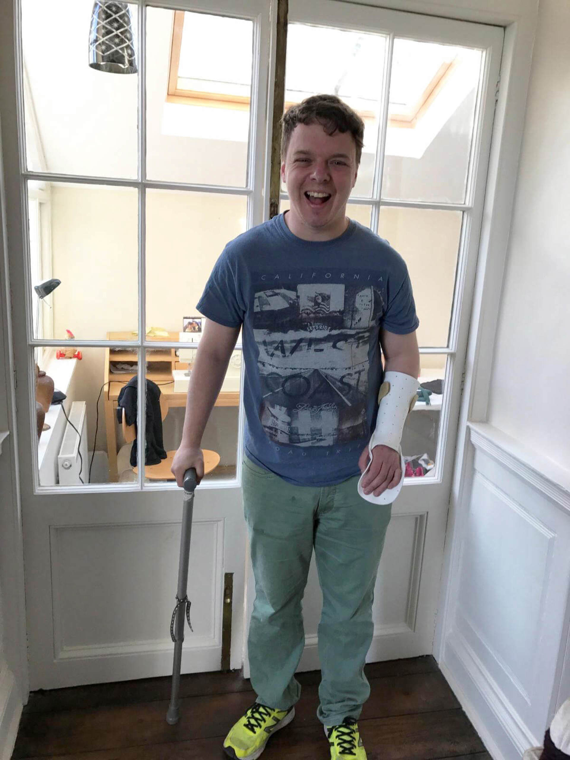 A former patient at home with their arm in a brace A former patient at home with their arm in a brace