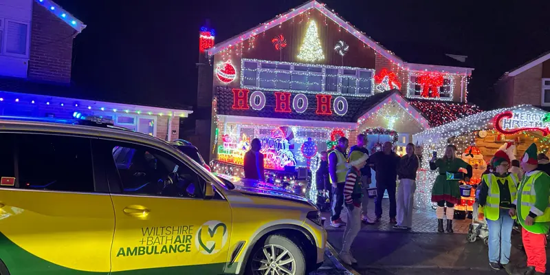 Yellow and green Wiltshire and Bath Air Ambulance critical care car at Sarum Avenue Christmas lights in Melksham