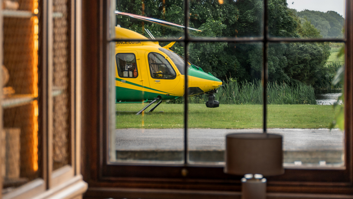 A yellow and green helicopter views through a paned window A yellow and green helicopter views through a paned window