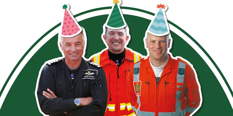 A pilot, doctor and paramedic wearing flight suits with cartoon style party hat stickers on
