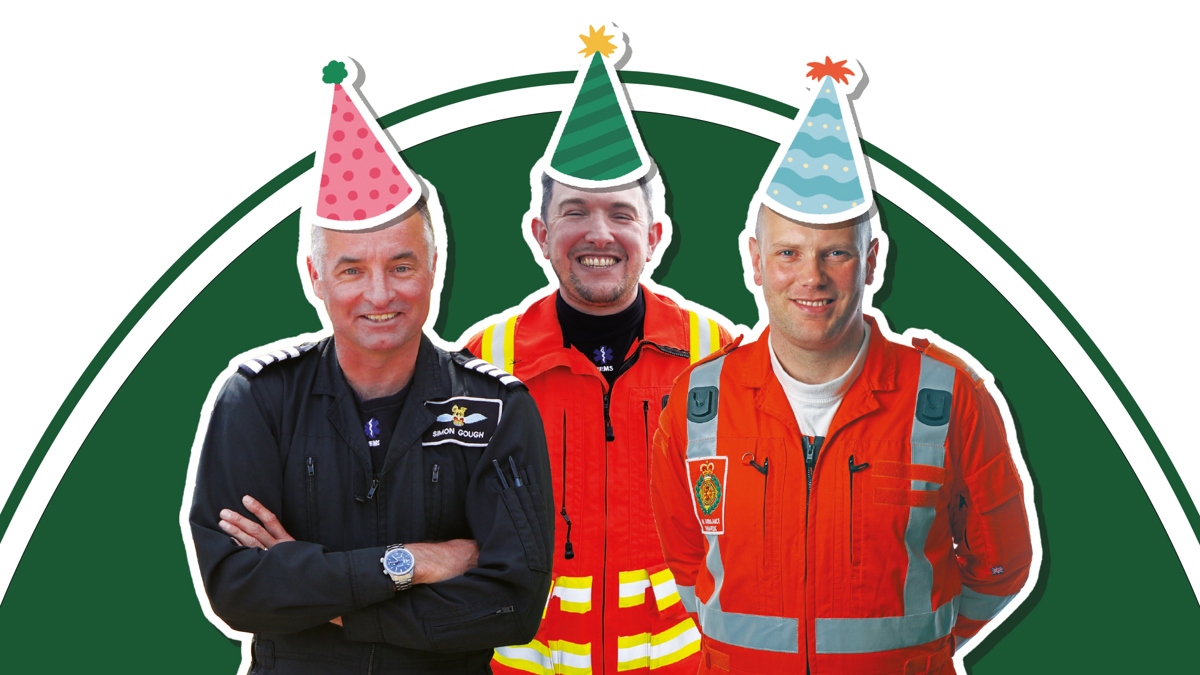 A pilot, doctor and paramedic wearing flight suits with cartoon style party hat stickers on