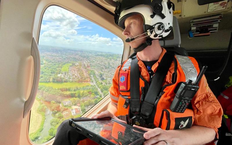A critical care paramedic in flight looking over Wiltshire countryside A critical care paramedic in flight looking over Wiltshire countryside