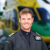 Pilot Rob Collingwood stood smiling with a blurred helicopter background. Pilot Rob Collingwood stood smiling with a blurred helicopter background.