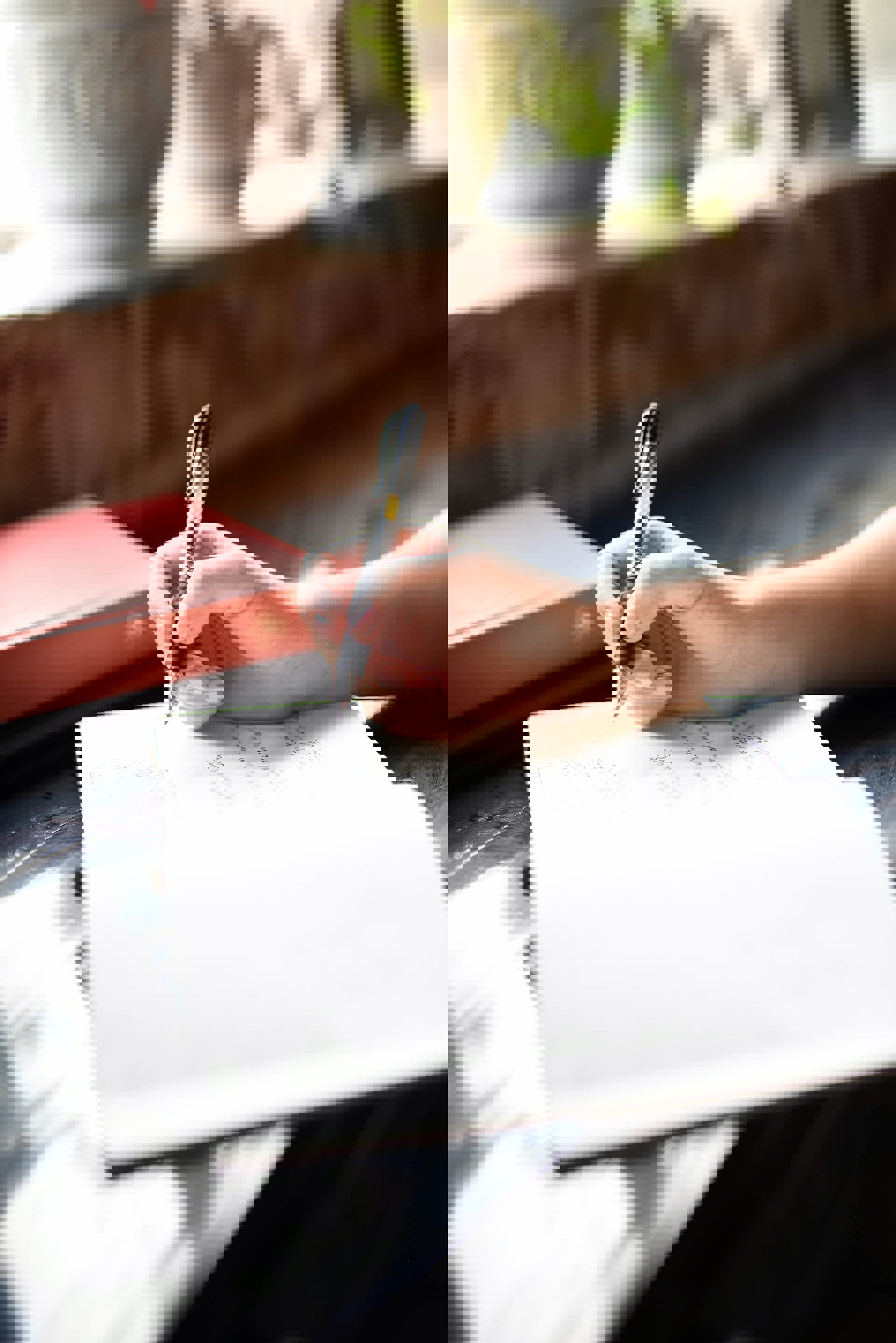 Someone writing their will and an option to find out more about writing your will for free at home Someone writing their will and an option to find out more about writing your will for free at home