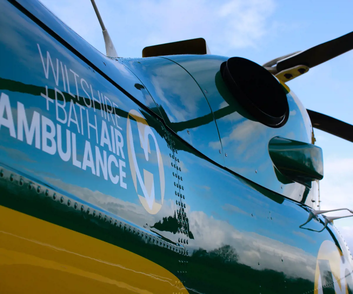 Wiltshire and Bath Air Ambulance helicopter showing logo and rotor blades Wiltshire and Bath Air Ambulance helicopter showing logo and rotor blades