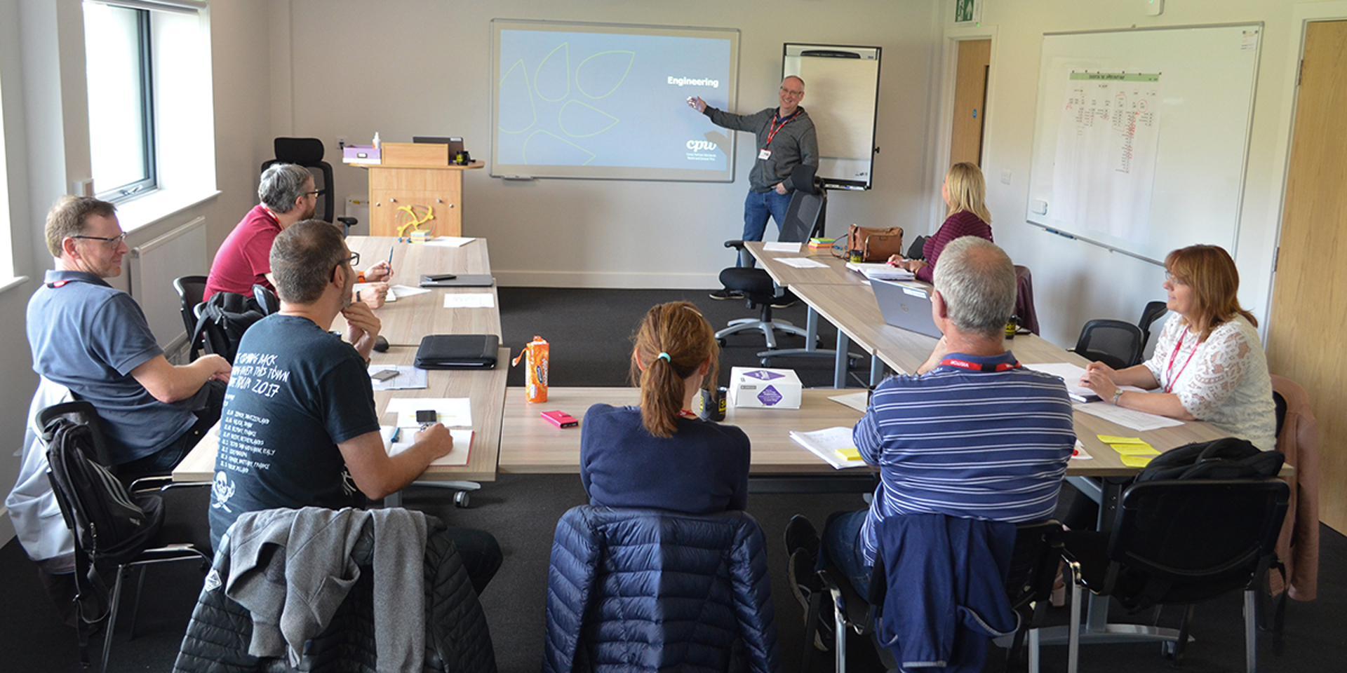 A group of people taking part in training in the Wiltshire Air Ambulance meeting room.