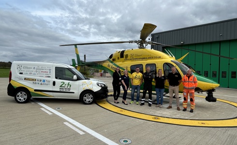 Mike Land with the 24hr van pull vehicle parked on the helipad next to the WAA helicopter Mike Land with the 24hr van pull vehicle parked on the helipad next to the WAA helicopter