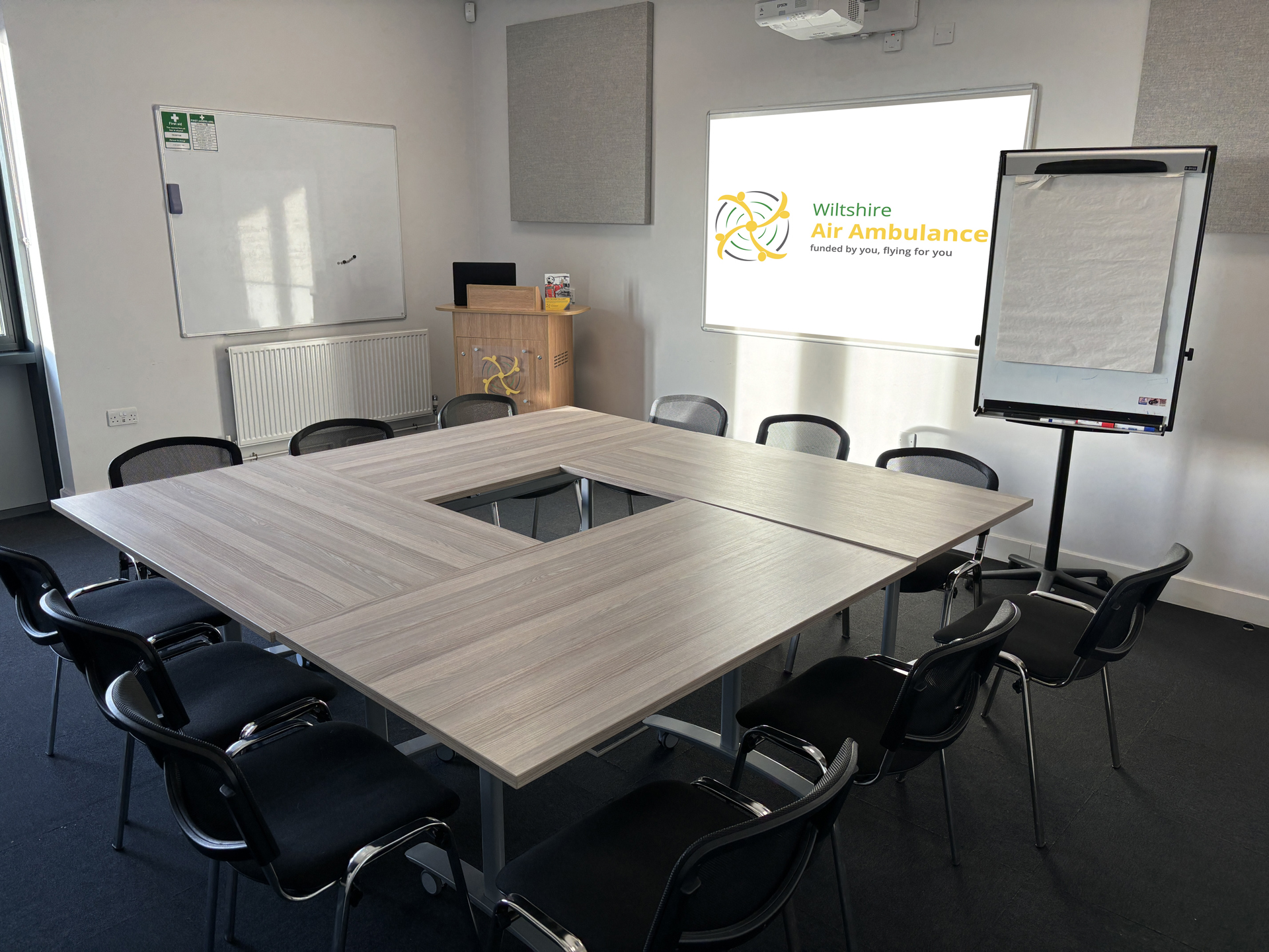 A photo of a hollow square table set up in a small meeting room A photo of a hollow square table set up in a small meeting room