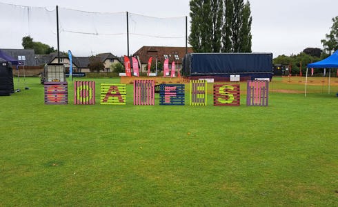 Pallets in a festival field with GOATFEST displayed on them in various colours