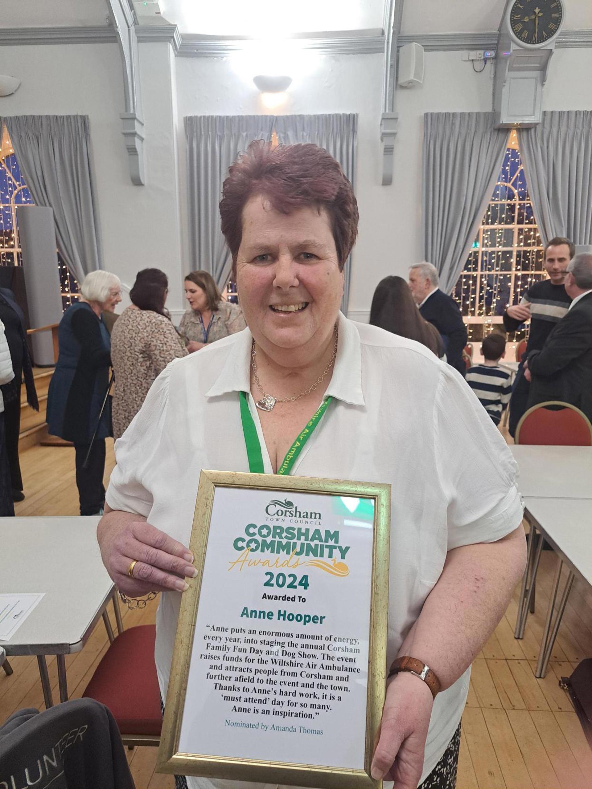 A lady holding a certificate in gold frame A lady holding a certificate in gold frame