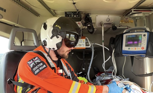 Dr Jono Holme delivering drugs to a patient in flight Dr Jono Holme delivering drugs to a patient in flight