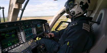 A pilot flying a helicopter
