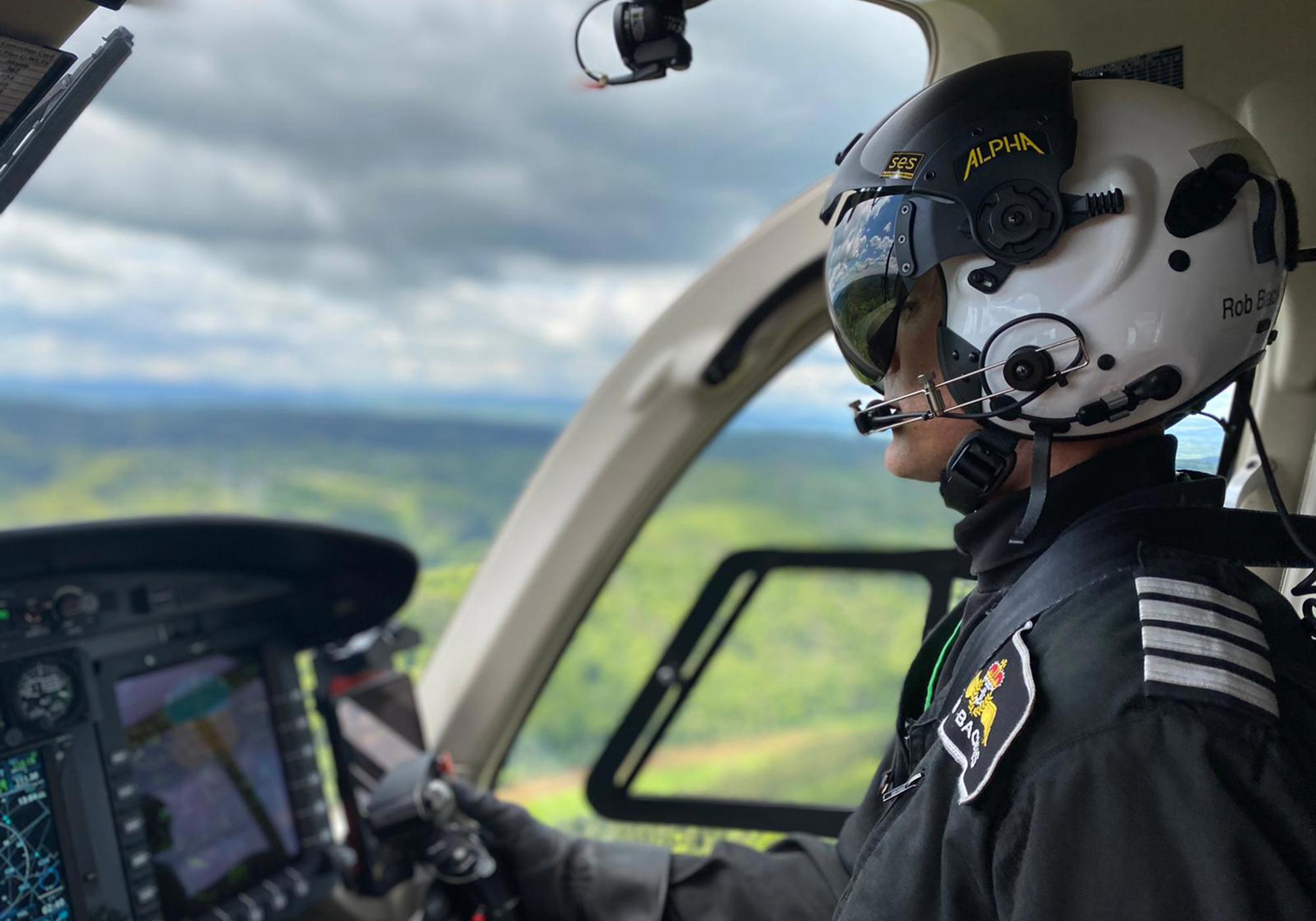 Pilot Rob wearing flight helmet, flying Wiltshire Air Ambulance's helicopter Pilot Rob wearing flight helmet, flying Wiltshire Air Ambulance's helicopter
