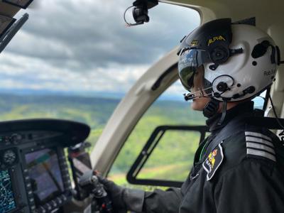Pilot Rob wearing flight helmet, flying Wiltshire Air Ambulance's helicopter Pilot Rob wearing flight helmet, flying Wiltshire Air Ambulance's helicopter