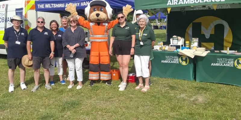 A group of charity workers in front of gazebos