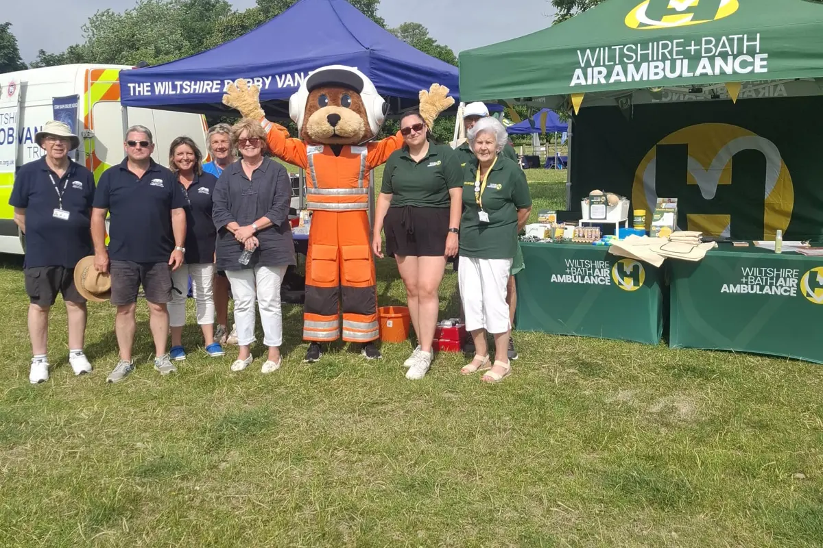 A group of charity workers in front of gazebos