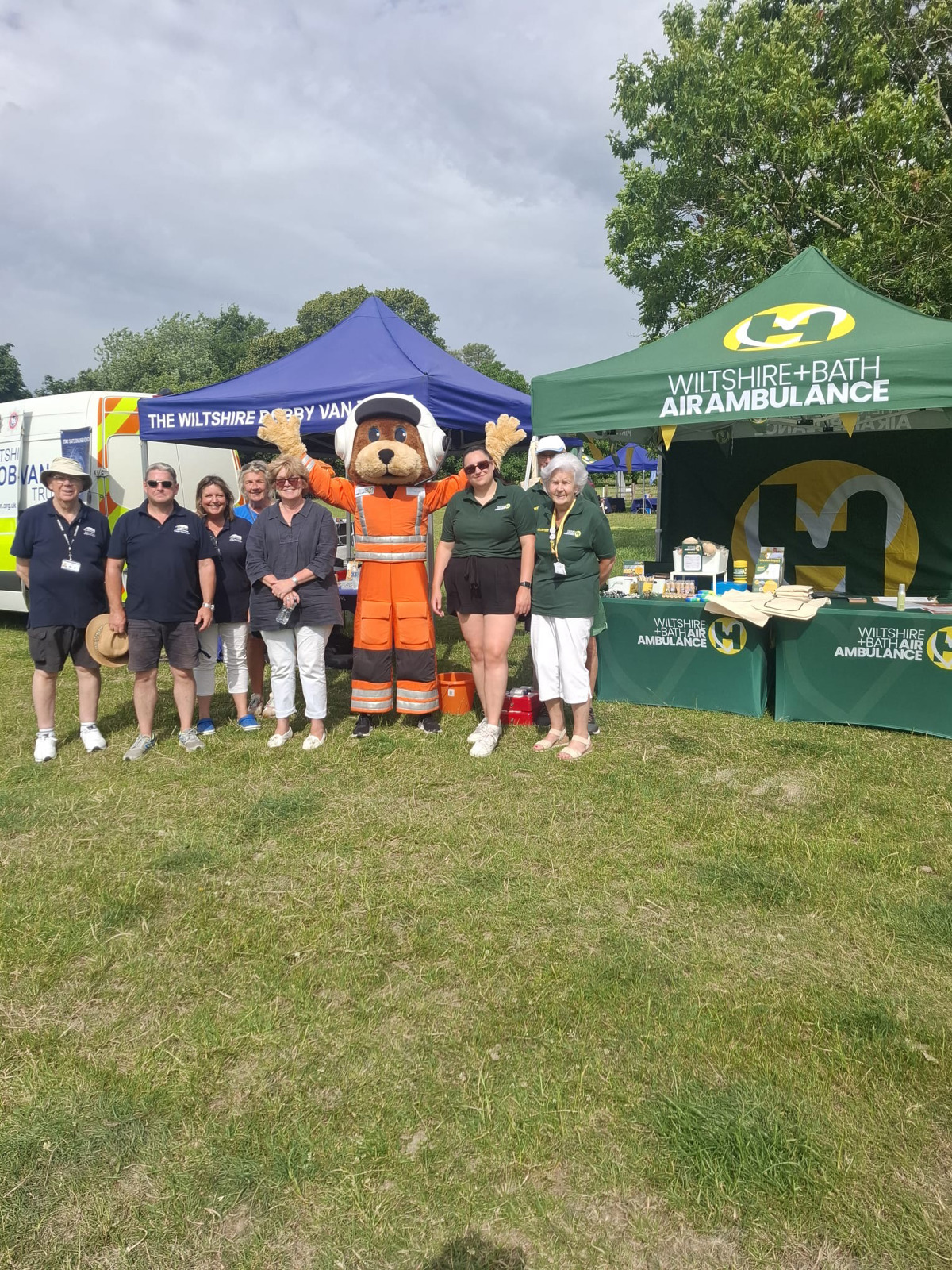 A group of charity workers in front of gazebos